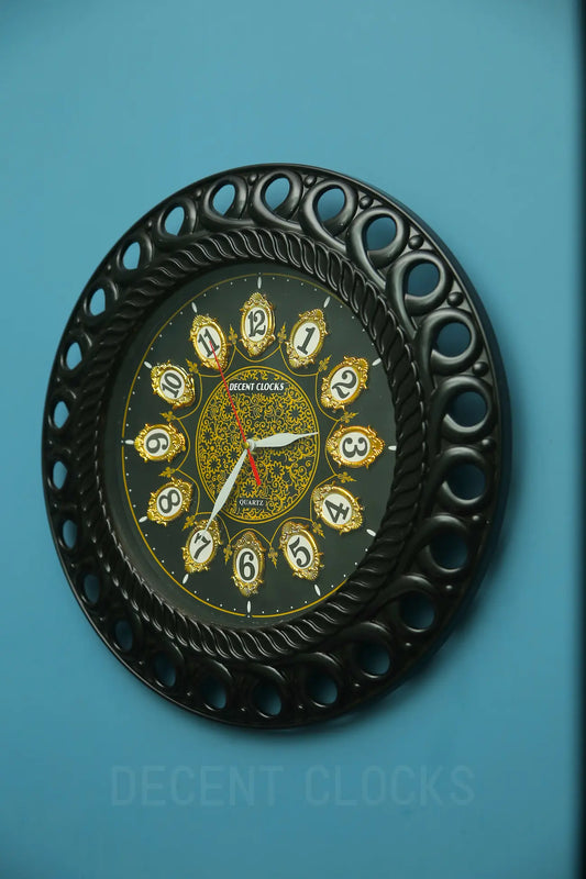 black-decorative-wall-clock-right-view on wall with light blue background