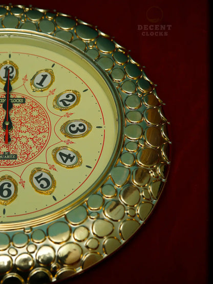 Decorative wall clock with royal golden  and green design on a red background