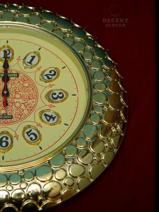 Decorative wall clock with royal golden  and green design on a red background