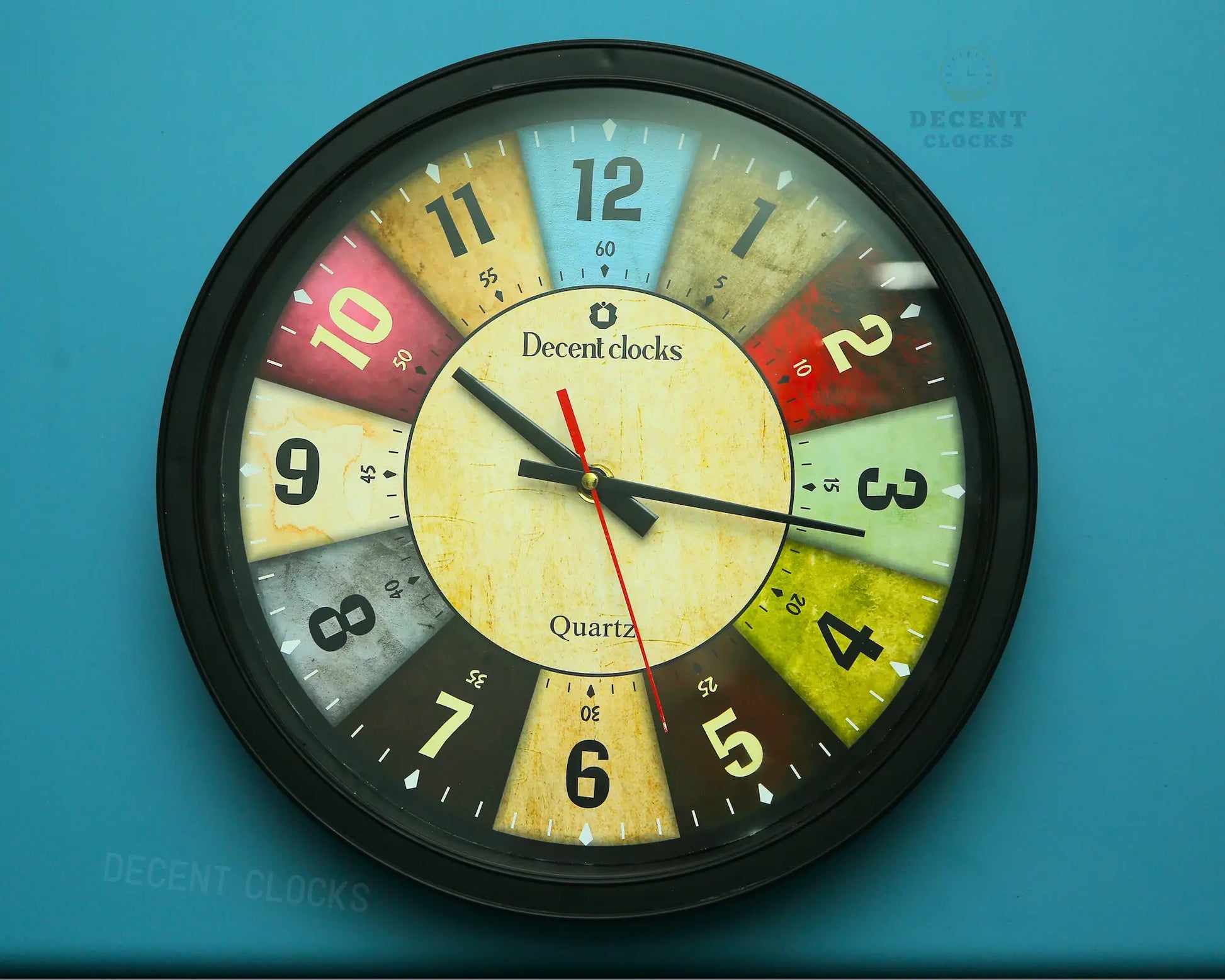 Colorful wall clock with 'Decent Clocks' branding on a blue background