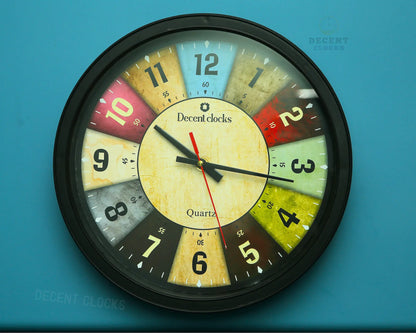 Colorful wall clock with 'Decent Clocks' branding on a blue background