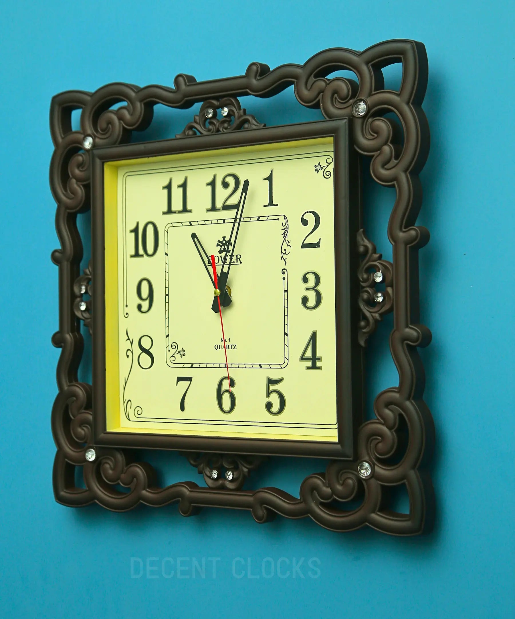 Royal Beidge square wall clock with ornate brown frame on a blue background