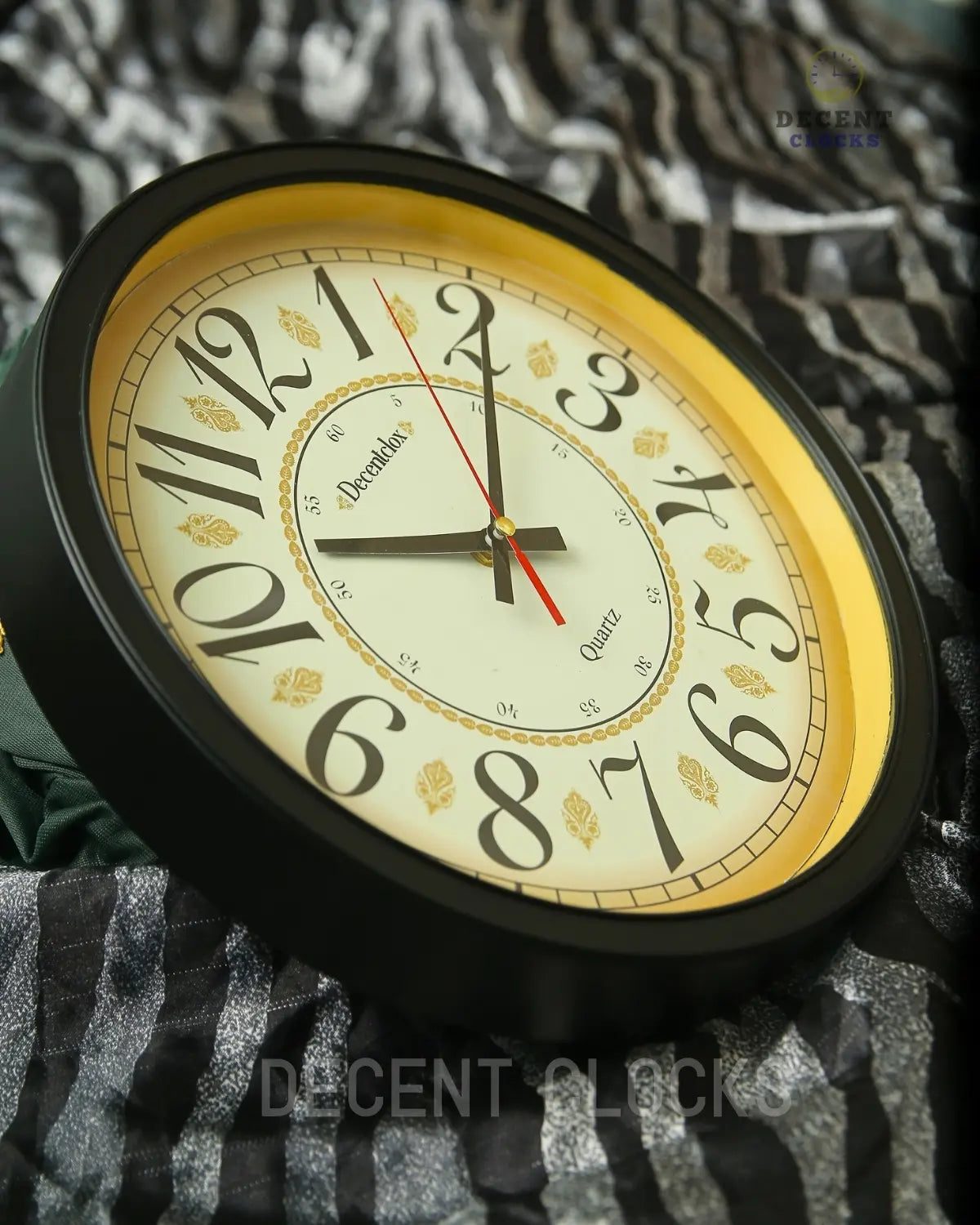 Wall clock with decorative face on a textured surface, branded 'Decent Clocks'.