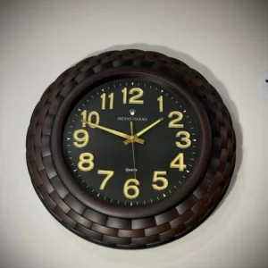 oversized black wall clock with golden numbers